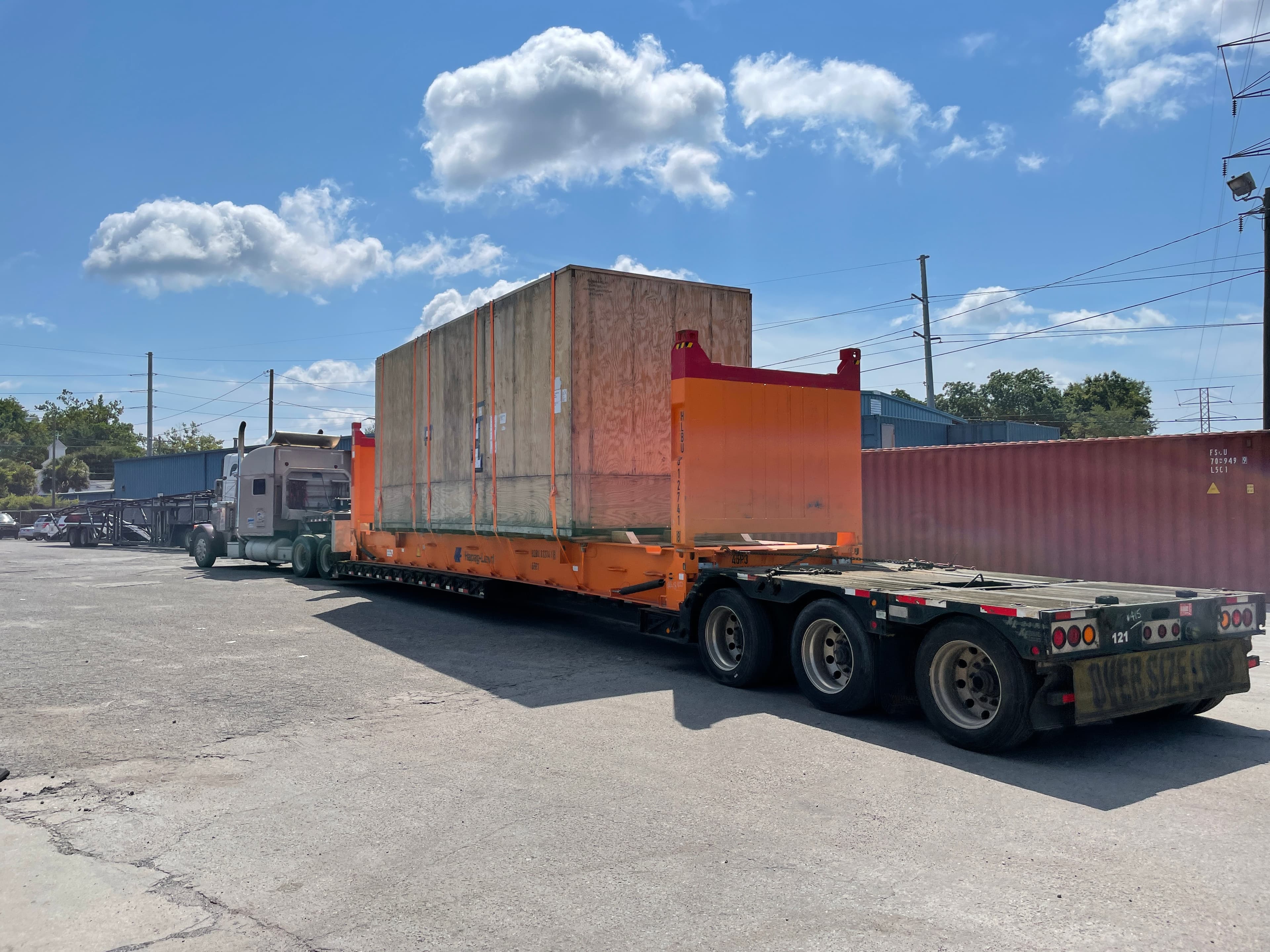 RGN trailer carrying a 40-foot flat rack
